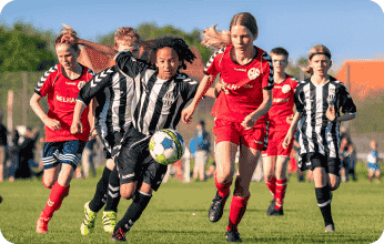 Children playing soccer at a community sports day